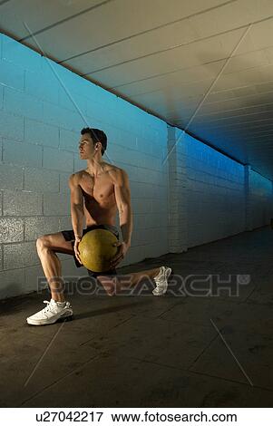 Stock Photo - man with medicine ball. Fotosearch