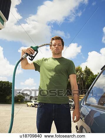 Man with Petrol Pump to Head View Large Photo Image Stock Image - Man with Petrol Pump to Head. Fotosearch