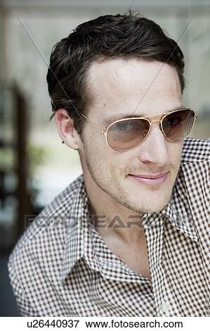 man with sunglasses smiling at viewer View Large Photo Image Stock Photo - man with sunglasses smiling at viewer. Fotosearch