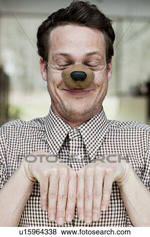 man with toy dog nose smiling View Large Photo Image Stock Photo - man with toy dog nose smiling. Fotosearch