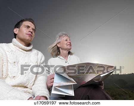Stock Photo - man & woman studying map. Fotosearch