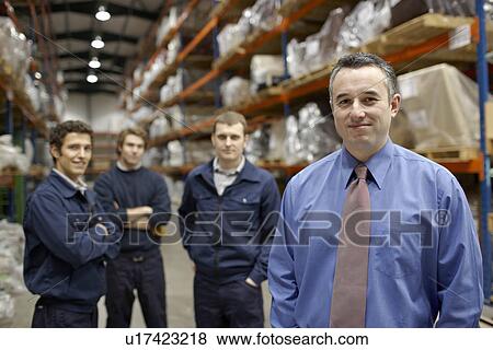 Stock Photo - Manager and workers in warehouse. Fotosearch