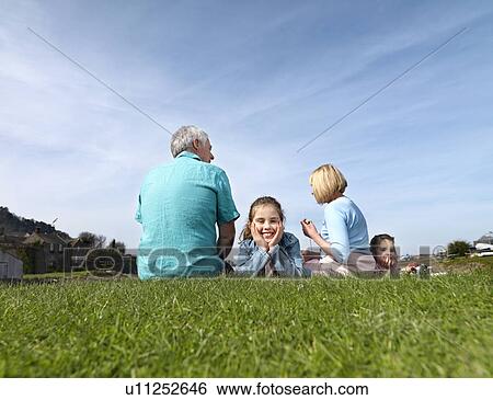 mature couple & children relax on grass View Large Photo Image Stock Photograph - mature couple & children relax on grass. Fotosearch