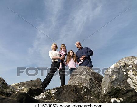 mature couple children standing on rocks View Large Photo Image Stock Image - mature couple children standing on rocks. Fotosearch