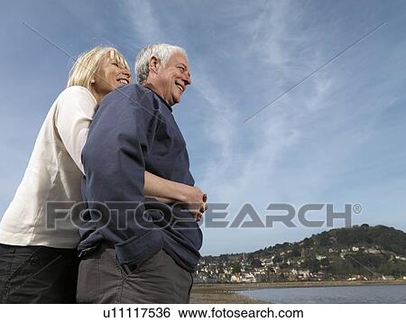 mature couple hugging on beach View Large Photo Image Stock Photograph - mature couple hugging on beach. Fotosearch