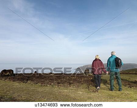 mature couple walking on moor View Large Photo Image Stock Image - mature couple walking on moor. Fotosearch