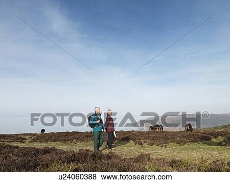 Stock Photo - mature couple walking on moor. Fotosearch