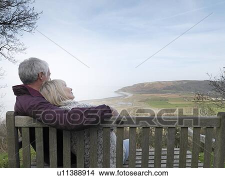 mature couple watching coastal view View Large Photo Image Picture - mature couple watching coastal view. Fotosearch