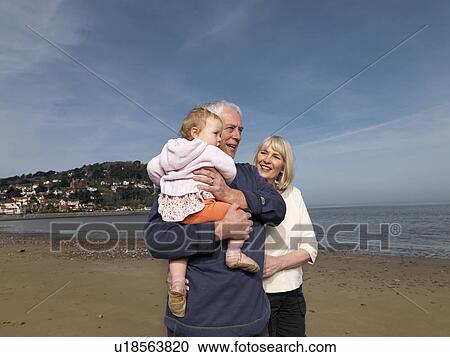 mature couple with baby on beach View Large Photo Image Stock Image - mature couple with baby on beach. Fotosearch