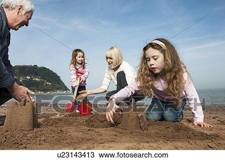 mature couple with children on beach View Large Photo Image Stock Image - mature couple with children on beach. Fotosearch