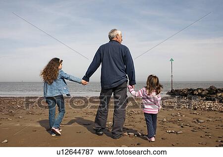 mature man with children on beach View Large Photo Image Stock Photo - mature man with children on beach. Fotosearch