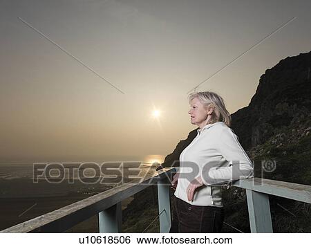 mature woman looking across sea View Large Photo Image Stock Photograph - mature woman looking across sea. Fotosearch