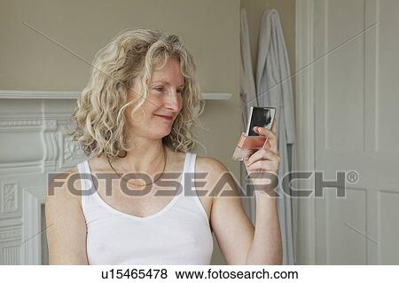 Mature woman looking in mirror View Large Photo Image Stock Photo - Mature woman looking in mirror. Fotosearch