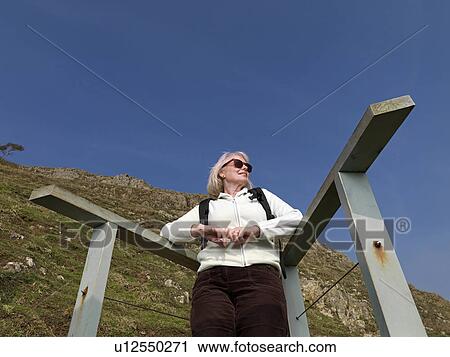 mature woman resting on hike View Large Photo Image Stock Image - mature woman resting on hike. Fotosearch
