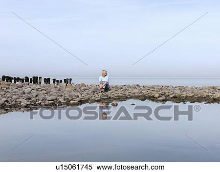 mature woman sitting on beach View Large Photo Image Stock Photography - mature woman sitting on beach. Fotosearch