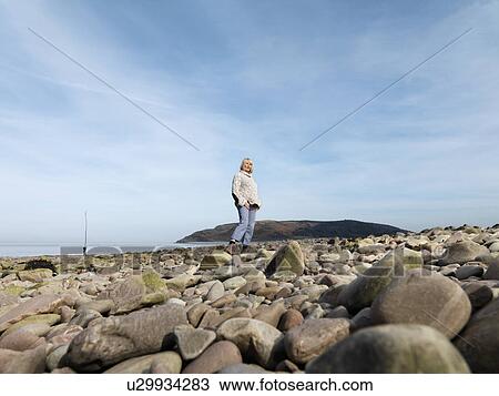 mature woman walking on beach View Large Photo Image Stock Image - mature woman walking on beach. Fotosearch