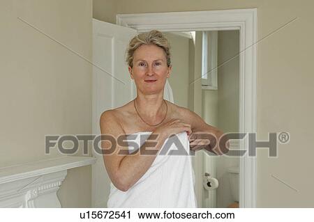 Mature woman wrapping towel around her View Large Photo Image Stock Image - Mature woman wrapping towel around her. Fotosearch