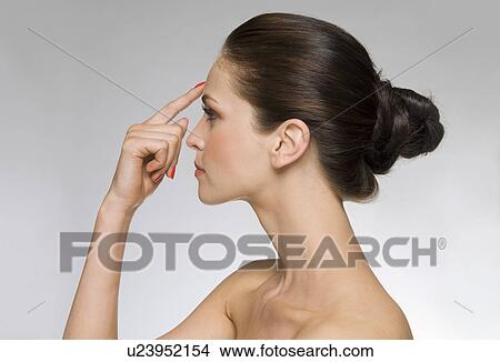 Model with finger to forehead View Large Photo Image Picture - Model with finger to forehead. Fotosearch