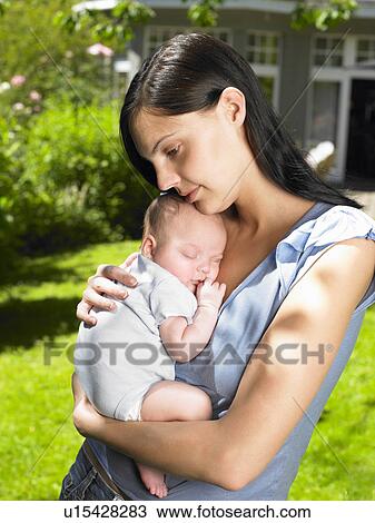 Stock Image - Mother and baby-boy in the garden. Fotosearch