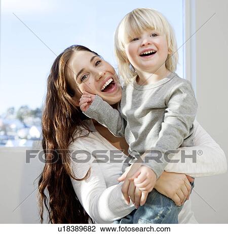 Mother and child cuddling and playing View Large Photo Image Stock Image - Mother and child cuddling and playing. Fotosearch