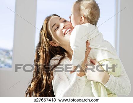 Mother and child cuddling View Large Photo Image Stock Photo - Mother and child cuddling. Fotosearch