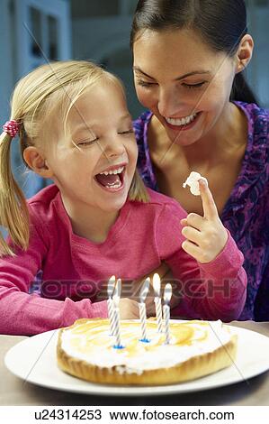 Stock Image - Mother and daughter celebrating birthday. Fotosearch