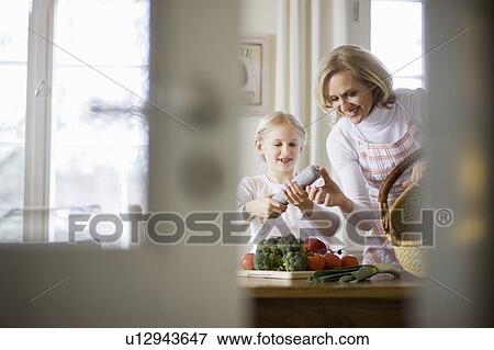 Stock Photo - mother and daughter cooking. Fotosearch