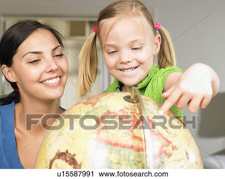 Stock Image - Mother and daughter exploring the world. Fotosearch