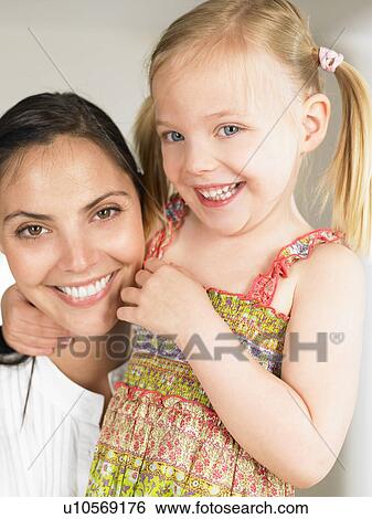 Stock Photograph - Mother and daughter smiling. Fotosearch