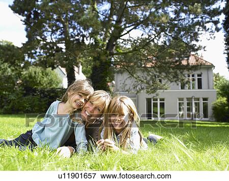 Mother and daughters in the garden View Large Photo Image Stock Photo - Mother and daughters in the garden. Fotosearch