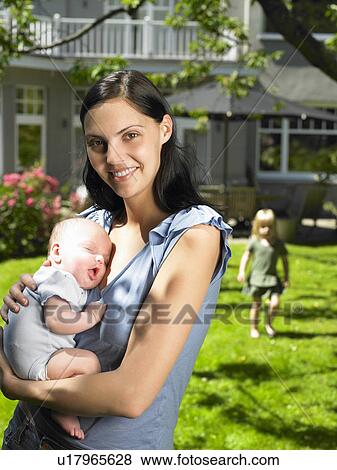Mother and kids in the garden View Large Photo Image Stock Photo - Mother and kids in the garden. Fotosearch