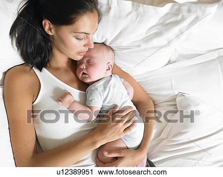 Mother and new-born baby, in bed View Large Photo Image Stock Image - Mother and new-born baby, in bed. Fotosearch