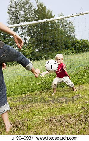 Mother And Son Playing Soccer View Large Photo Image Stock Photo - Mother And Son Playing Soccer. Fotosearch
