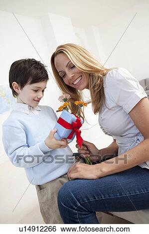 mother and son with present View Large Photo Image Stock Photograph - mother and son with present. Fotosearch