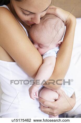 Mother bearing her baby View Large Photo Image Stock Image - Mother bearing her baby. Fotosearch