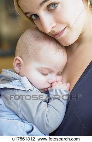 Mother carrying her baby View Large Photo Image Stock Image - Mother carrying her baby. Fotosearch