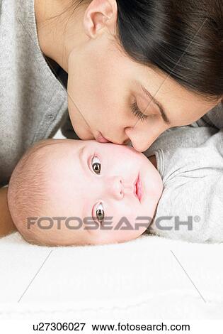Mother kissing her baby View Large Photo Image Stock Photo - Mother kissing her baby. Fotosearch