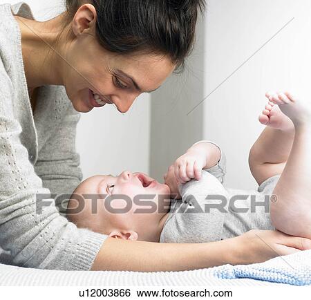 Mother playing with her baby-boy View Large Photo Image Stock Photograph - Mother playing with her baby-boy. Fotosearch
