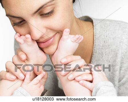 Mother playing with her baby's feet View Large Photo Image Stock Image - Mother playing with her baby's feet. Fotosearch