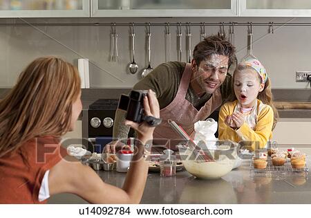 mother taking picture of cooking family View Large Photo Image Picture - mother taking picture of cooking family. Fotosearch