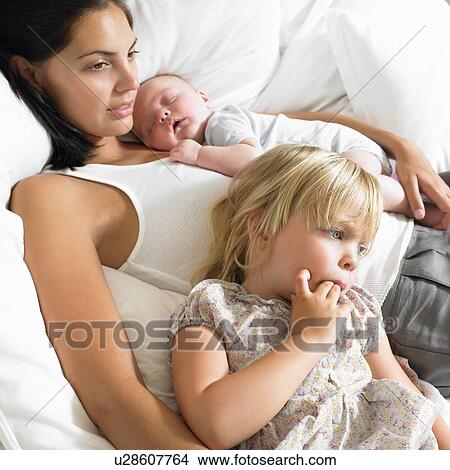 Picture - Mother with babies in bed. Fotosearch