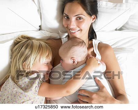 Mother with babies in bed View Large Photo Image Stock Image - Mother with babies in bed. Fotosearch