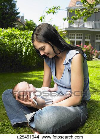 Picture - Mother with her baby in the garden. Fotosearch