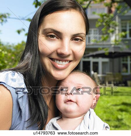 Mother with her baby in the garden View Large Photo Image Stock Image - Mother with her baby in the garden. Fotosearch