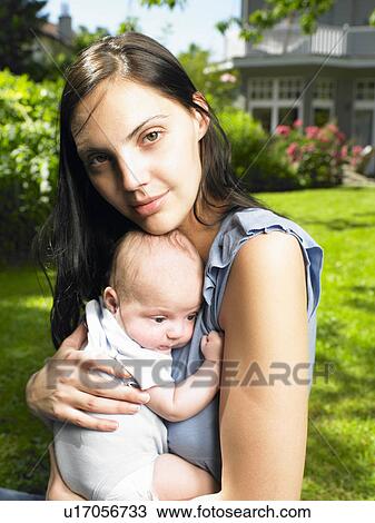 Stock Image - Mother with her baby in the garden. Fotosearch