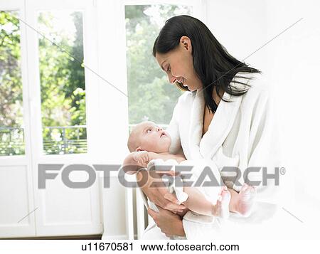Stock Image - Mother with her baby, smiling. Fotosearch