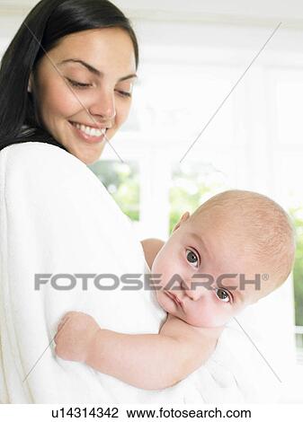 Stock Image - Mother with her baby, smiling. Fotosearch
