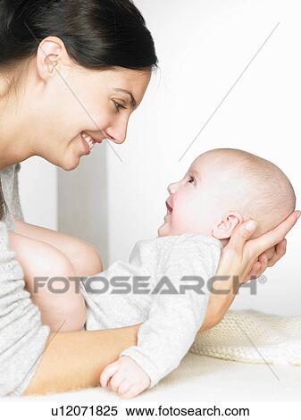 Mother with her baby, smiling View Large Photo Image Stock Photography - Mother with her baby, smiling. Fotosearch