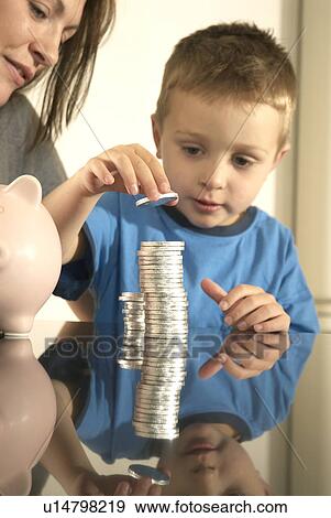 mum and son and money pile View Large Photo Image Stock Photo - mum and son and money pile. Fotosearch