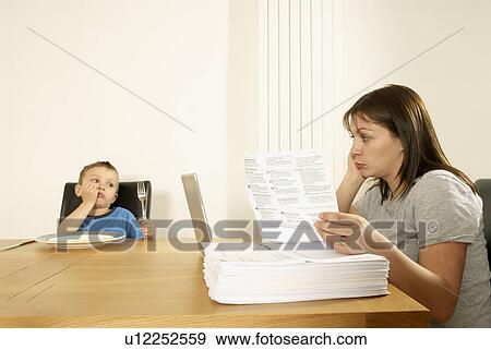 Stock Photo - mum and son at table. Fotosearch
